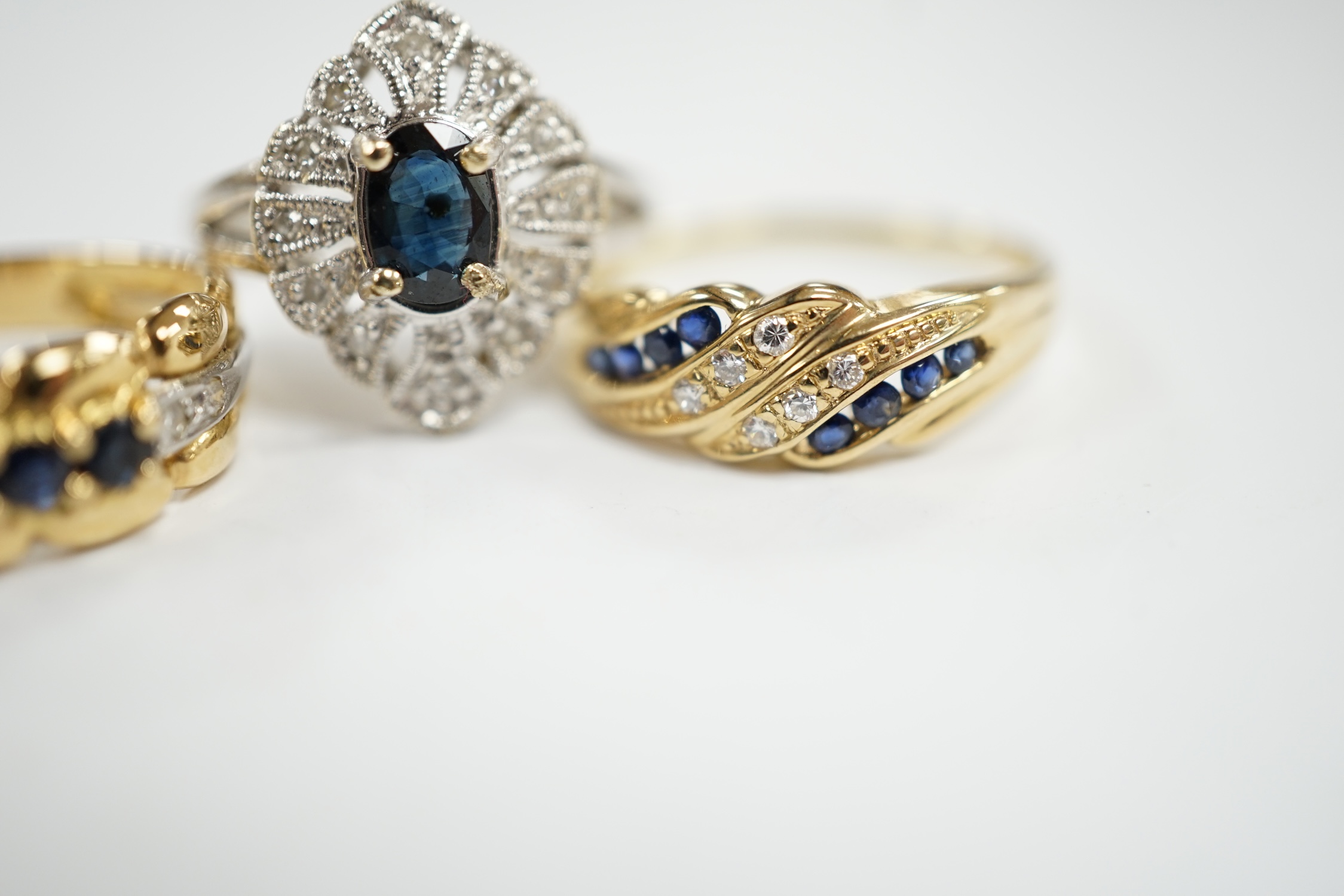 Three assorted 18k, sapphire and diamond chip set rings, including one French ring, gross weight 8.6 grams.